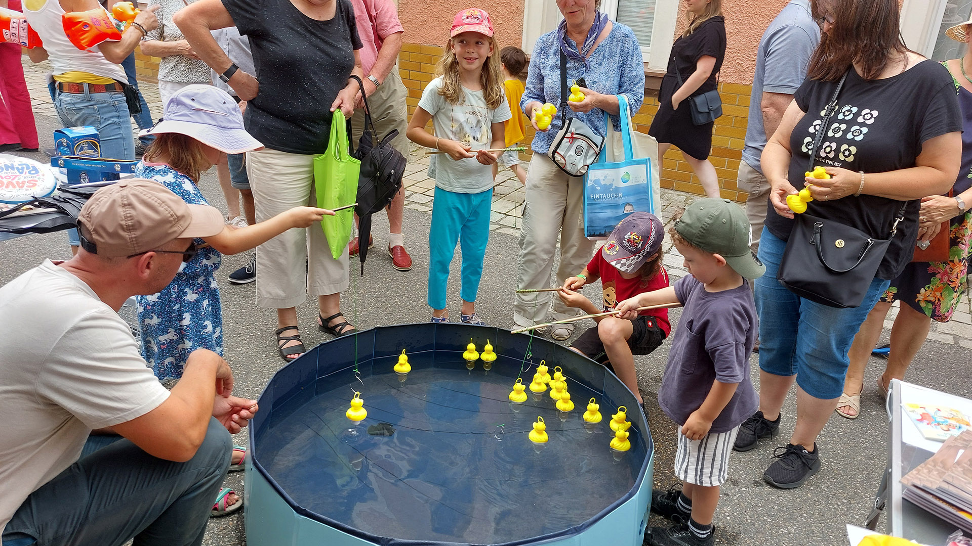 Kinder angeln gelbe Gummienten bei Sommerveranstaltung